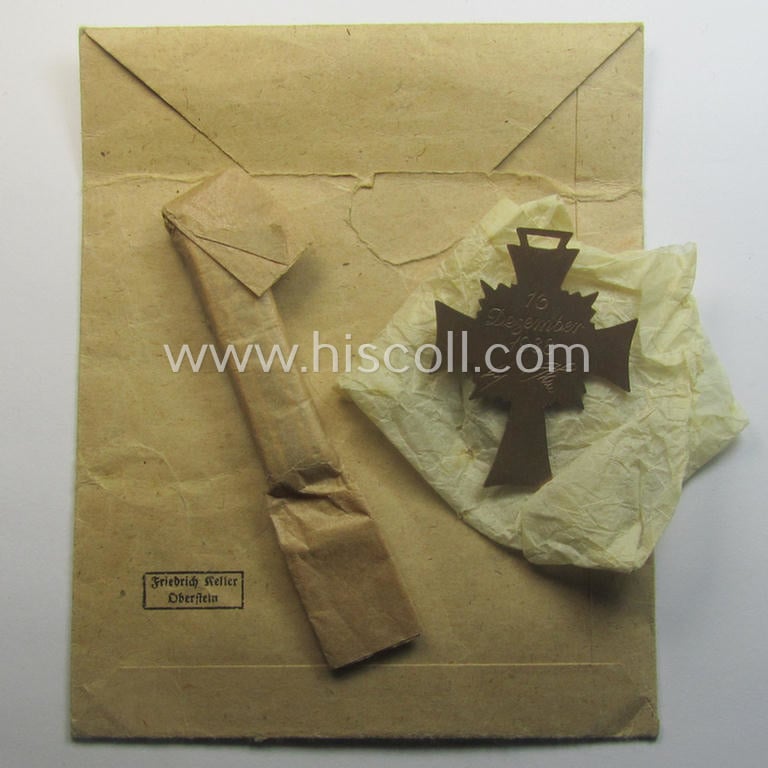 'Ehrenkreuz der deutschen Mutter - dritte Stufe' (or: bronze-class mothers'-cross) that came together with its long-sized (and mint!) ribbon and that came stored in its period pouch (by the maker: 'Friedrich Keller - Oberstein')