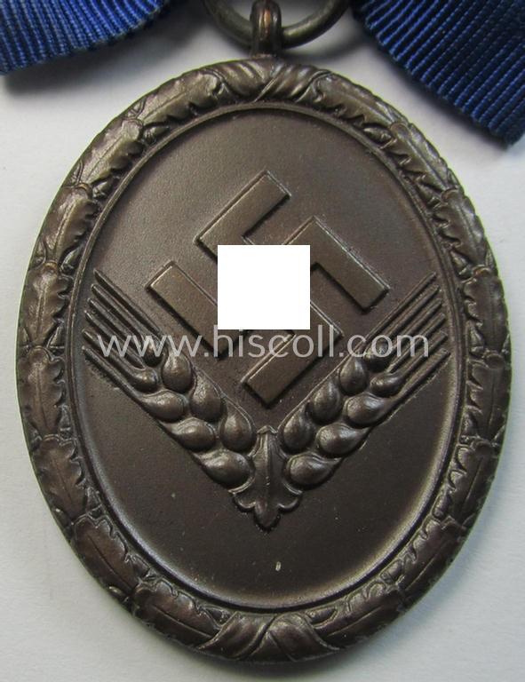 Superb example of a: 'Reichsarbeitsdienst der weiblichen Jugend' (or: RADwJ) so-called: 'Dienstauszeichnung 4. Stufe in Bronze' that comes mounted onto its period-attached ('bow-tie'-shaped!) ribbon (ie. 'Bandabschnitt')