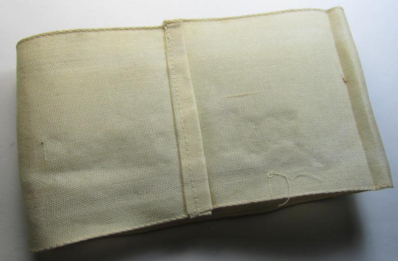 Neat, beige/white-coloured- and/or linnen-based armband (ie. 'Armbinde') as was executed in the 'thicker-styled' fabric as was intended for WH (Heeres) staff-members working as: 'Hilfs-Krankenträger'