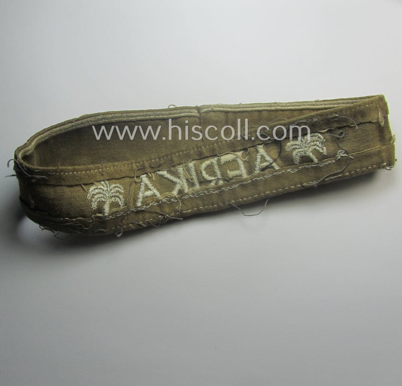 Cleary worn, WH cuff-title (ie. 'Ärmelstreifen') entitled: 'Afrika' (that bears a printed 'RbN.'-numeral!) being a minimally shortened example that comes in an overall very nice- (ie. issued and clearly worn ie. once tunic-attached-), condition
