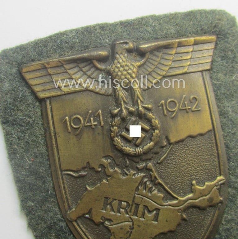 Stunning - and scarcely encountered! - WH (Heeres ie. Waffen-SS) 'Krim'-campaign-shield (as was produced by the maker: 'Josef Feix u. Söhne' ie. 'JFS') and that comes mounted onto its original field-grey-coloured- and/or woolen-based 'backing'