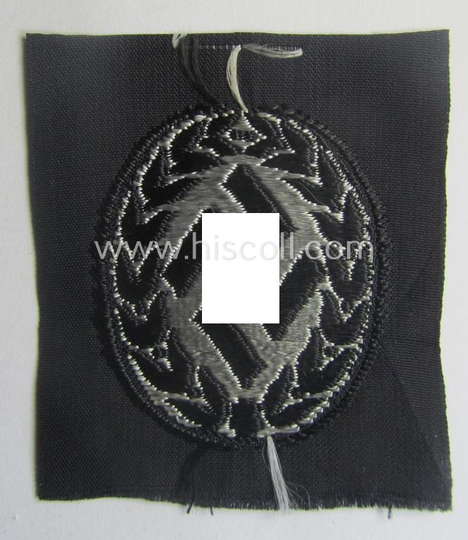 EM- (ie. NCO-) type, so-called: 'Schutzmannschaften' (or: 'Schuma') cap-badge as executed in greyish-coloured thread onto a black-coloured- (ie. 'SS-Polizei'- ie. 'SD'-related-) background