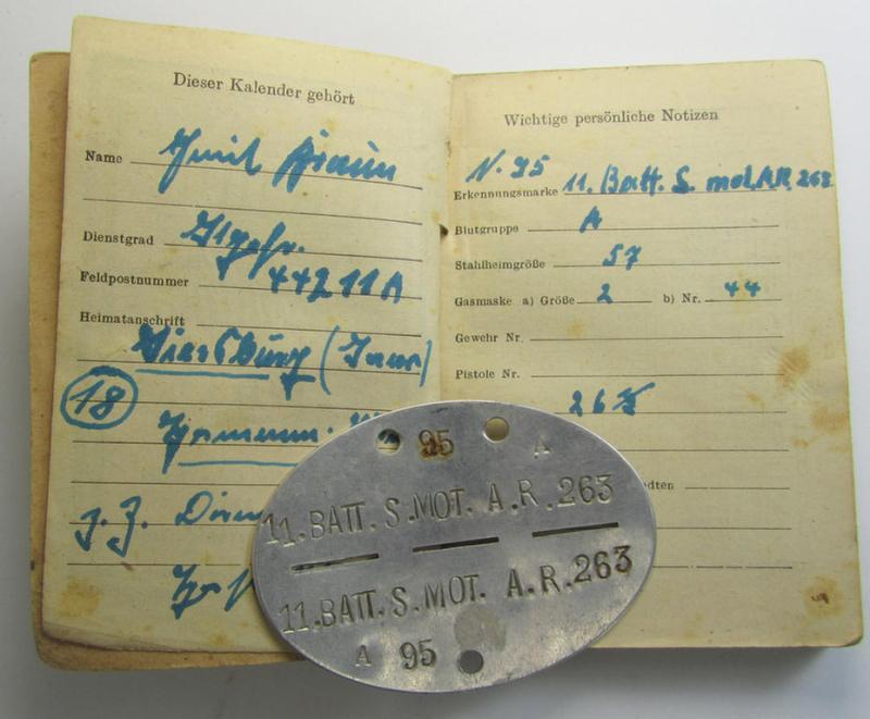 Interesting, aluminium-based WH (Heeres) ie. 'mot. Artillerie'-related ID-disc bearing the clearly stamped unit-designation: '11.Batt.S.Mot.A.R. 263' and that comes together with its 1945-dated agenda (ie. 'Kalender') as stored for decades