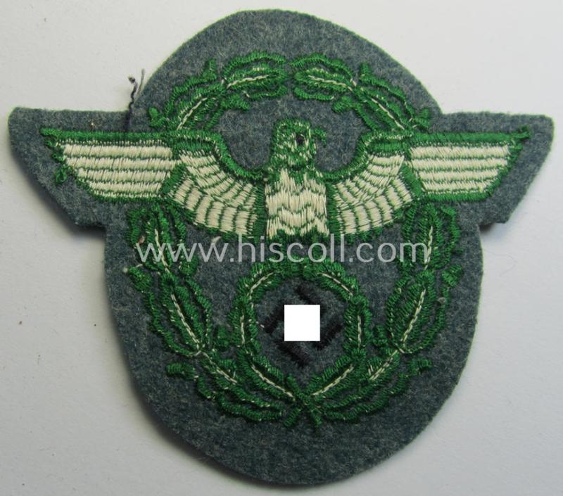 Attractive - and simply never used- nor worn! - Police- (ie. 'Polizei'- ie. 'Gendarmerie'-) related machine-embroidered-pattern arm-eagle, as executed in bright-green-coloured linnen on a typical 'Polizei'-coloured- and/or woolen-based, backgro...