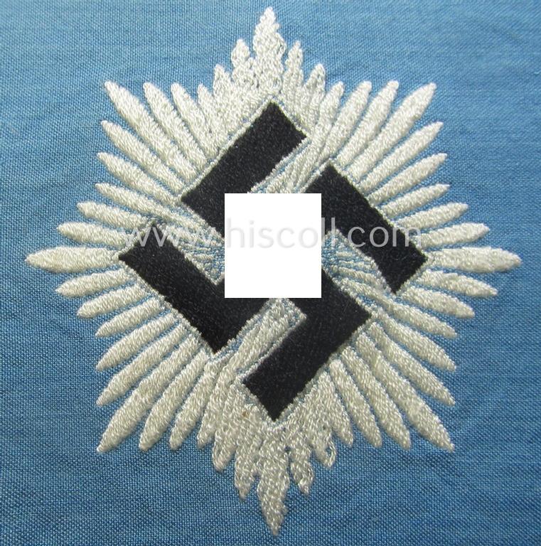Light-blue-coloured and neatly 'BeVo'-woven, so-called: RLB (or: 'Reichsluftschutzbund') 'Amtsträger'-armband depicting the typical 'RLB'-logo (without lettering) and showing an interwoven makers'-designation (ie. '34'-numeral)