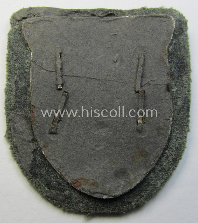 Superb, WH (Heeres o. Waffen-SS) 'Krim'-campaign-shield that comes mounted onto its original, field-grey-coloured 'backing' and that comes in a surely issued-, minimally worn and/or (I deem) carefully tunic-removed-, condition