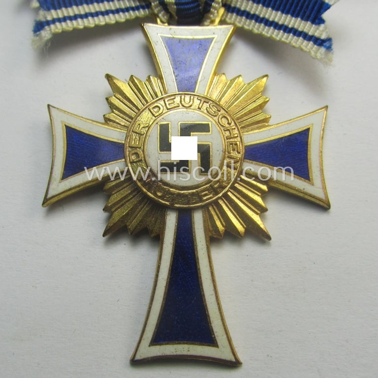 'Ehrenkreuz der deutschen Mutter - erste Stufe' (or: golden-class mothers'-cross) being a hardly used example that comes mounted onto its (unusually confectioned!) ribbon as issued and/or recently found