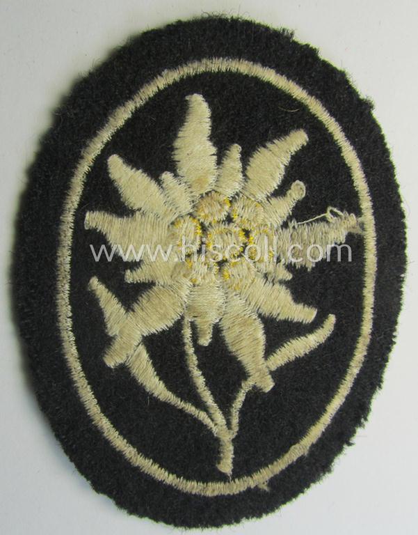 Neat - and I deem truly used and/or worn! - Waffen-SS-pattern, black-coloured sleeve-insignia (ie. 'Ärmelabzeichen') depicting an: 'Edelweiss'-flower as used by the various 'Gebirgsjäger'- (ie. mountain-troops-) related divisional-staff