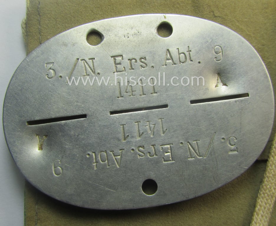 Aluminium-based, WH (Heeres-) signals'- (ie. 'Nachrichten'-) related ID-disc bearing the clearly stamped unit-designation: '3./N.Ers.Abt. 9' and that comes stored in its period-pouch as issued and/or worn