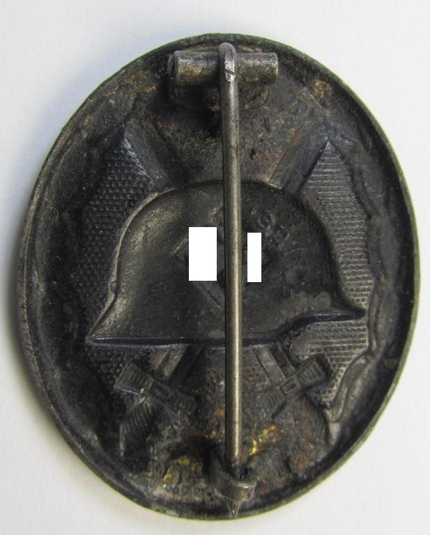 Moderately used- and maker- (ie. '32'-) marked example of a black-class wound-badge (or: 'Verwundeten-Abzeichen in Schwarz') being an example that was produced by the Austrian-based maker (ie. 'Hersteller') named: 'W. Hobacher'