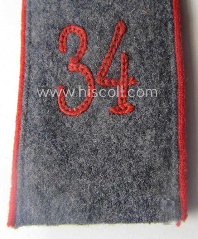 Single, WH (LW) 'cyphered', EM-type shoulderstrap as piped in the bright-red-coloured branchcolour as intended for usage by a: 'Soldat' who served within the: 'Flak-Artillerie-Abteilungs 34'