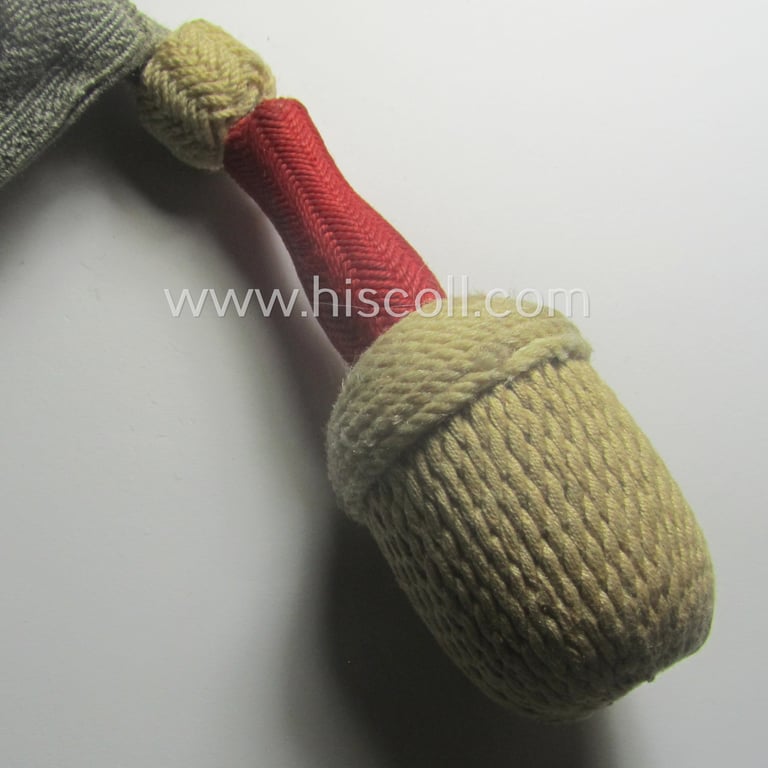 Bright-white-, red- and/or greyish-silver-coloured, EM- (ie. NCO-) type side-arm knot (ie. 'Portepee' ie.: 'Troddel') as was used for the various WH-bayonets and that comes in an overall very nice- (ie. 'virtually mint- ie. unissued'-), condition