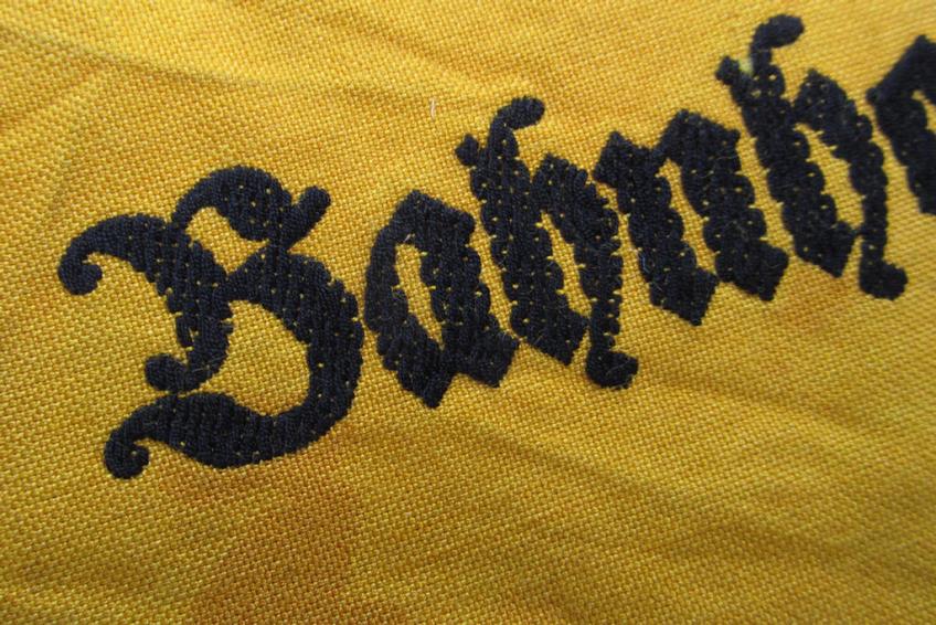Very nice - and scarely encountered! - Wehrmacht-related, golden-yellow-coloured and/or typical linnen-based armband (ie. 'Armbinde') as executed in 'BeVo'-weave-pattern entitled: 'Bahnhofswache'