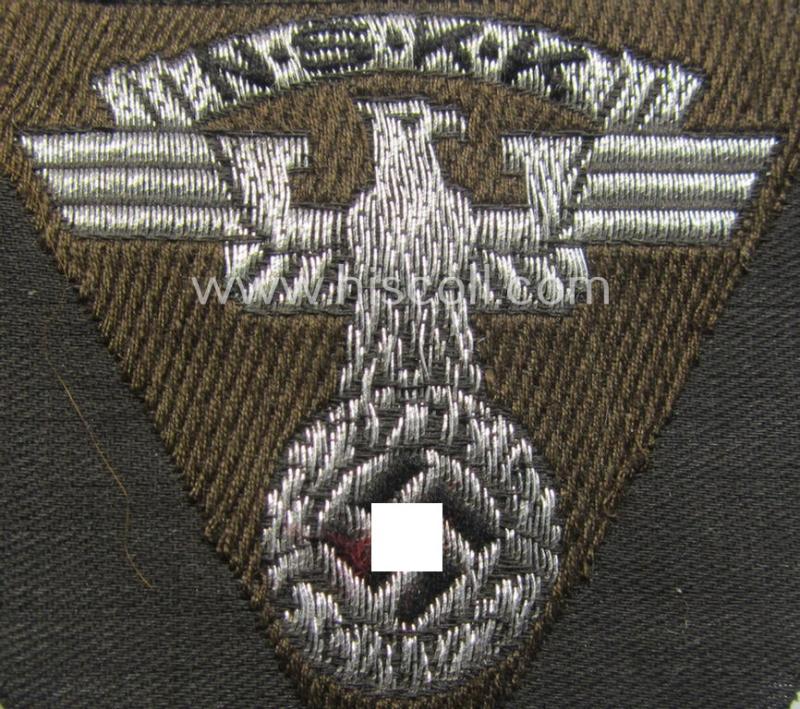 Attractive - and 'virtually mint'! - so-called: N.S.K.K. (ie. 'National Socialistisches Kraftfahr Korps') side-cap-eagle (ie. 'Adler für Schiffchenmütze') being a 'flat-wire-woven'-example that comes mounted onto a darker-brown-coloured backg...