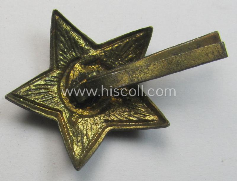 Unusal item that originated from a German soldier: a Russian, smaller-sized and/or WWII-period, enamelled star-shaped cap-badge showing the communist logo on a bright-red-coloured surface (that comes in a cap-removed condition)