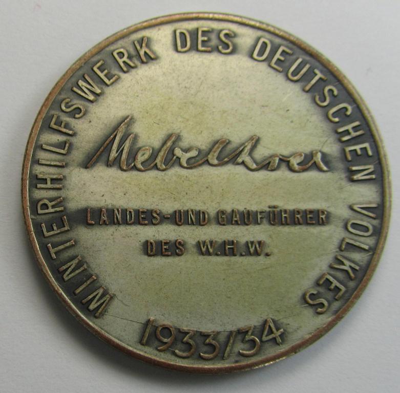 Neat - I deem 'Buntmetall'-based - WHW-related supporter plaque (ie. 'Erinnerungs- o. nichttragbare Auszeichnungsplakette') that shows a portrait of the: 'Reichskanzler' Adolf Hitler surrounded by the text: 'Hitlers Dank - Gau Halle-Merseburg...