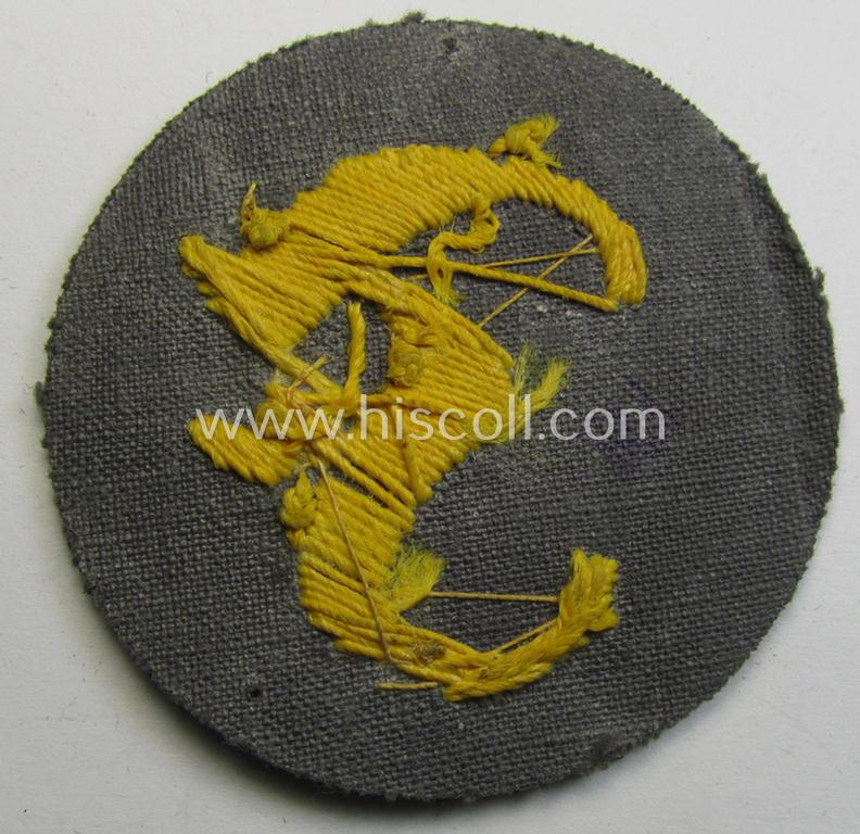 WH (Heeres) so-called: trade- and/or special-career arm-insignia (ie. 'Laufbahn- o. Tätigkeitsabzeichen') as was specifically intended for an army: 'Feuerwerker' (being a neatly hand-embroidered variant on darker-green-coloured wool)