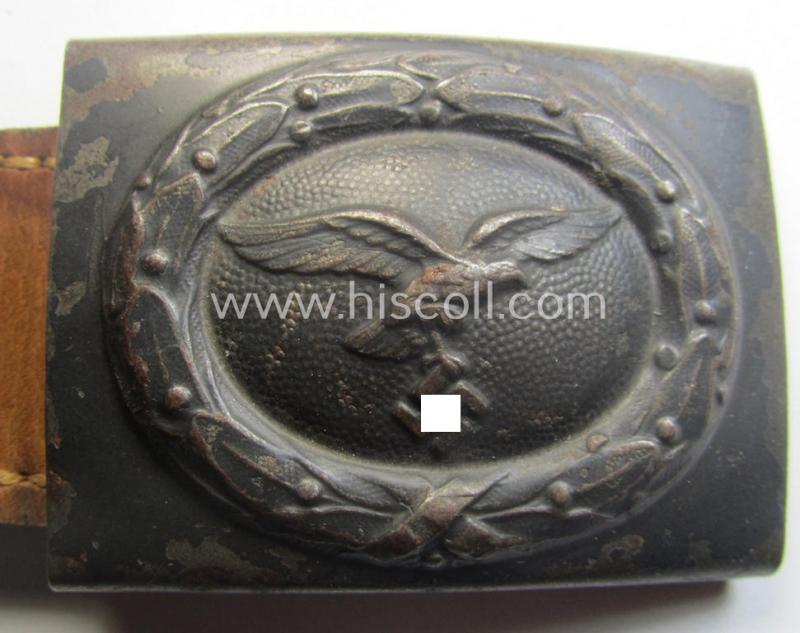 WH (Luftwaffe) bluish-grey-coloured, steel-based belt-buckle being a maker- (ie. 'R. Sieper & Söhne'-) marked example that comes mounted onto its leather-based tab