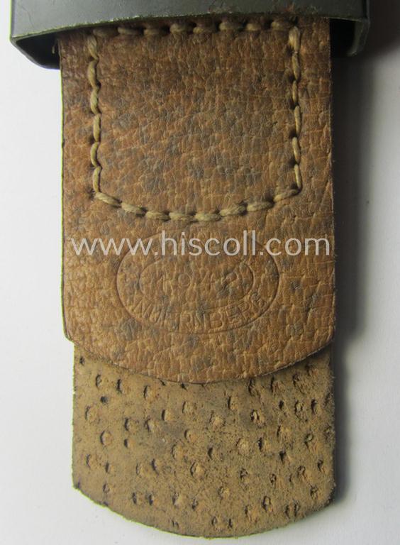 WH (Heeres) 'standard-pattern', field-grey-toned- and steel-based belt-buckle being a maker- (ie. 'H. Arld - Nuernberg'-) marked- and/or: '1942'-dated example that comes mounted onto its leather- (ie. 'pig-skin'-) based tab