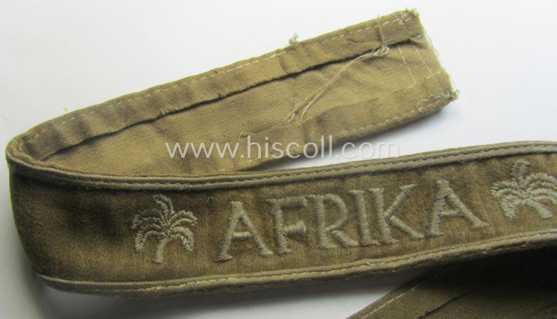 WH cuff-title (ie. 'Ärmelstreifen') entitled: 'Afrika' (being an example that bears a printed 'RbN.'-numeral ('RBN.0/0250/2340') and that comes in an issued, clearly worn- and/or most certainly once tunic-attached, condition)