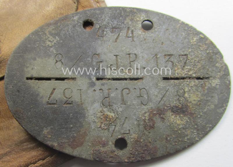 Zinc-based, WH (Heeres-) ie. 'Gebirgsjäger'-related ID-disc (ie. 'Erkennungsmarke') bearing the clearly stamped unit-designation that reads: '8./G.J.R. 137' and that comes stored in its leather-based pouch as issued and found