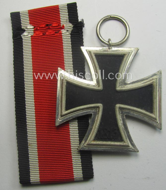 Iron Cross 2nd class (or: 'EK II. Klasse') being a maker- (ie. '23'-) marked example that comes together with its confectioned ribbon (ie. 'Bandabschnitt') as was produced by the maker (ie. 'Hersteller'): 'AG für Heeresbedarf….'