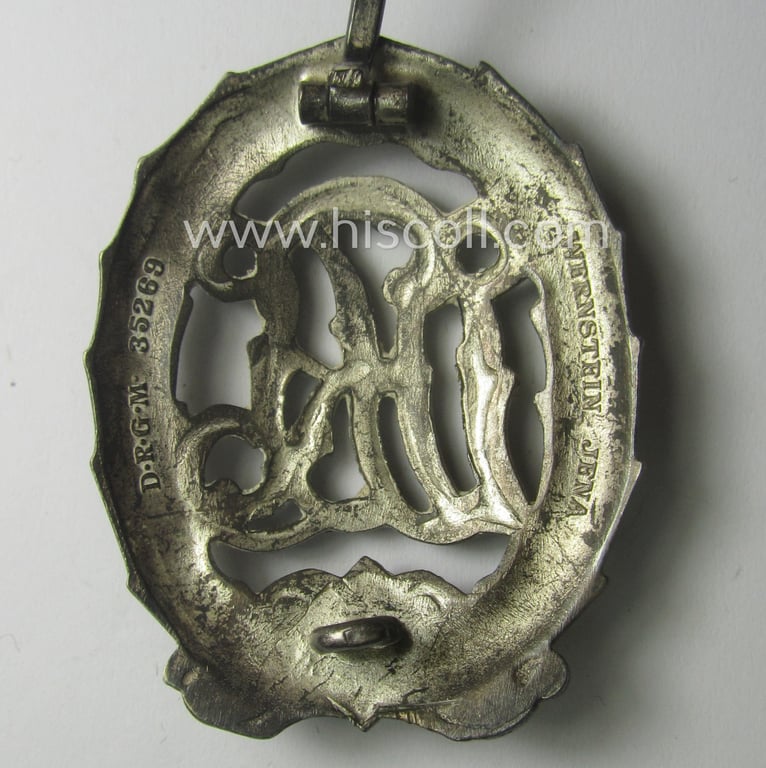 'Reichssportabzeichen DRL in Silber' (or: DRL sports'-badge in silver) being a just moderately worn- ie. used example that is nicely maker- (ie. 'Wernstein - Jena'-) marked on its back