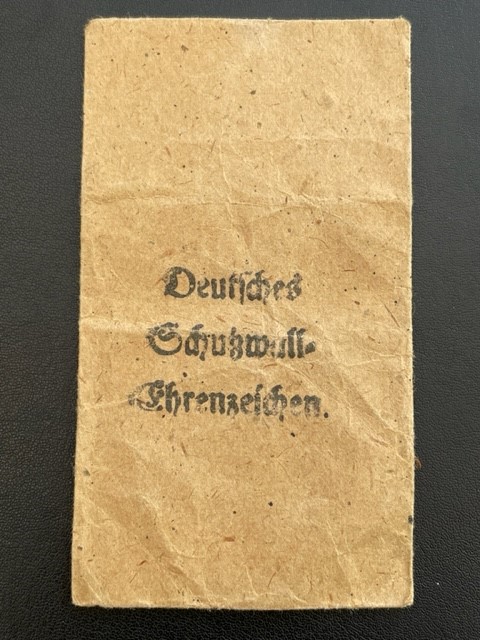 WWII GERMAN WEST WALL MEDAL WITH PAPER ISSUE PACKET.
