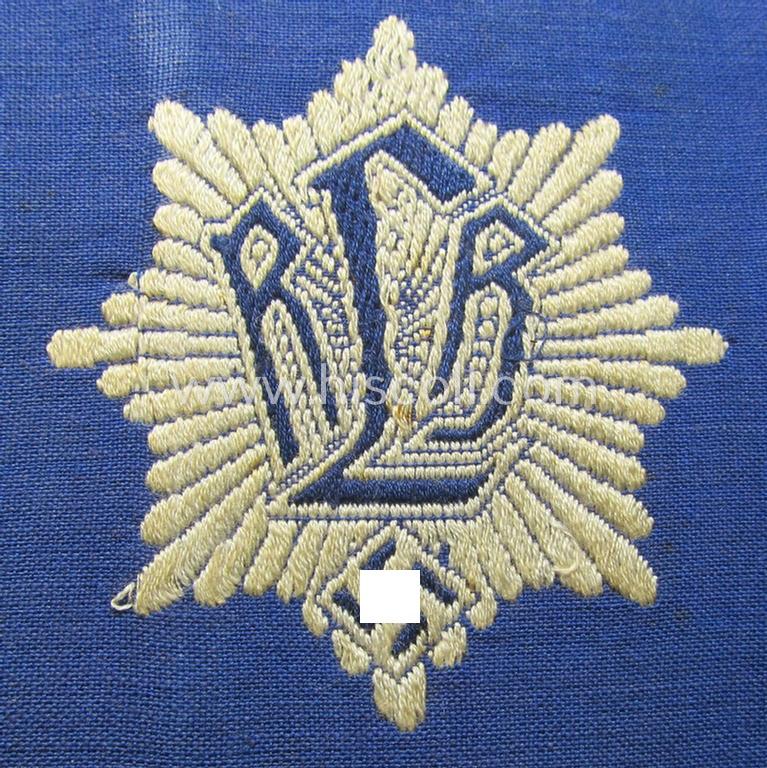 Attractive, darker-blue-coloured so-called: RLB (or: 'Reichsluftschutzbund') 'Amtsträger'-armband depicting the typical 'RLB'-logo (with lettering) and showing an interwoven 'Ges.Gesch.'-patent-pending-designation