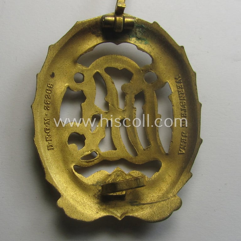 Superb, 'Reichssportabzeichen DRL in Gold' (or: golden-class DRL sports'-badge) being a maker- (ie. 'Wernstein - Jena'-) marked example and that comes with its accompanying miniature