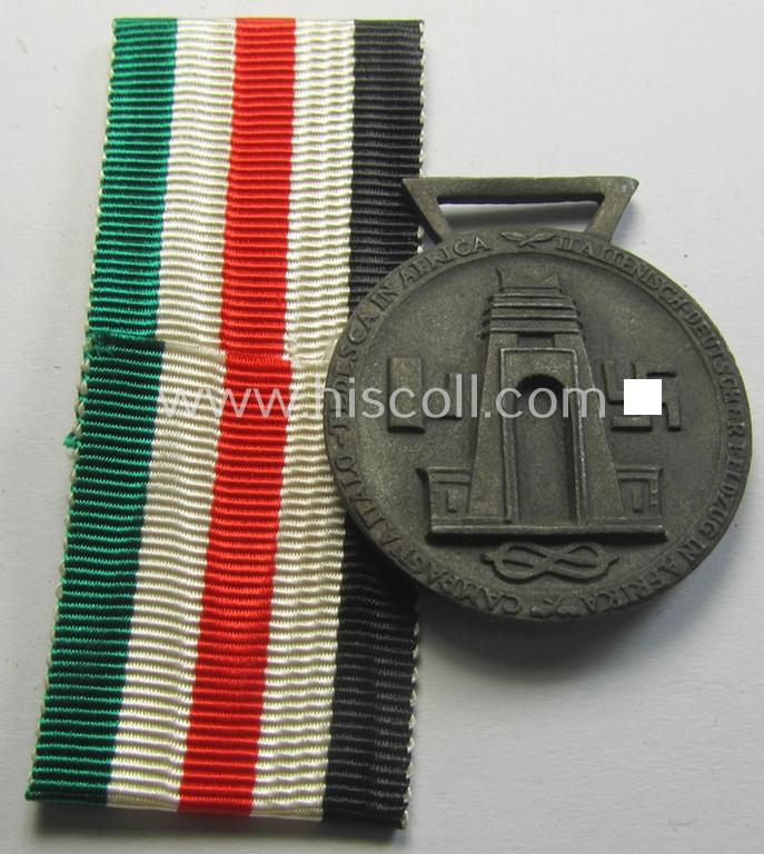 Attractive, bronze-coloured- (and I deem 'Feinzink'-based-) example of a: 'Deutsch-Italienische Feldzugsmedaille' (or: German-Italian campaign medal) that came together with its (regular-sized- and never mounted) piece of original ribbon