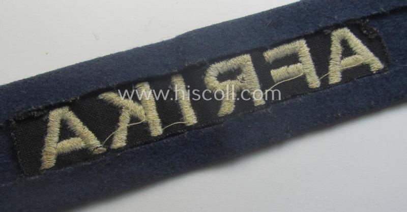 Darker-blue toned, WH (Luftwaffe) cuff-title (ie. 'Ärmelstreifen') entitled: 'Afrika' (being a full-length example that comes in an issued-, used and/or carefully tunic-removed, condition)