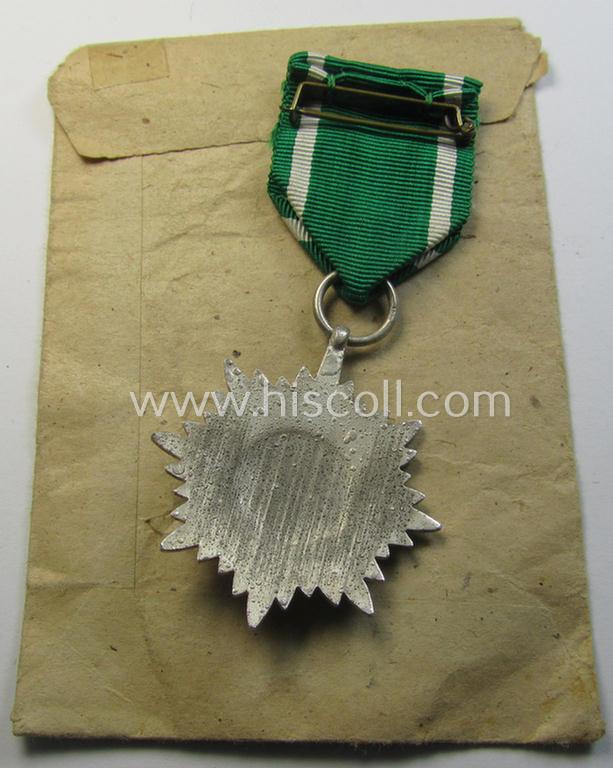 Superb, WH-related: 'Verdienstsauszeichnung für Angehörige der Ostvölker, 2. Kl. in Silber ohne Schwertern' being a maker- (ie. '100'-) marked example that comes stored in its period 'Zellstoff'-based pouch