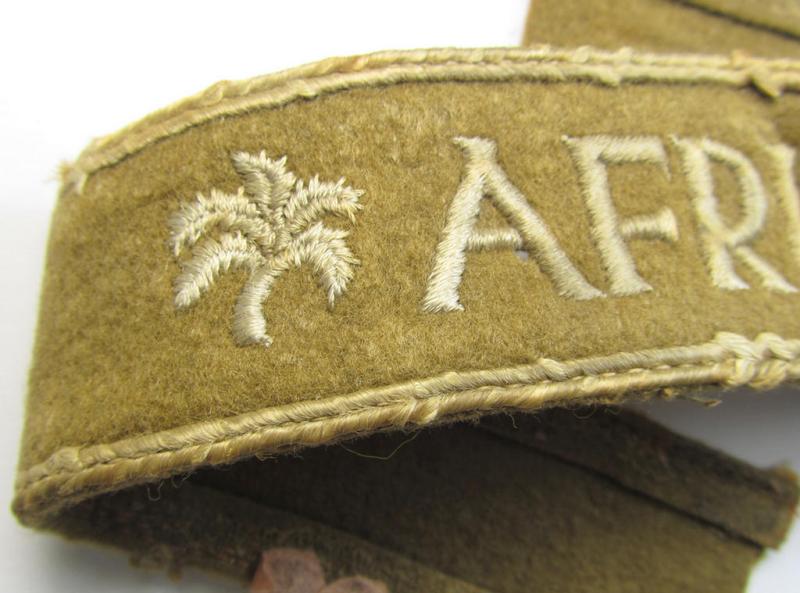 Attractive, WH (LW o. Heeres) cuff-title (ie. 'Ärmelstreifen') entitled: 'Afrika' (being a period-shortened- and woolen-based example that comes in a clearly issued- and/or worn condition)
