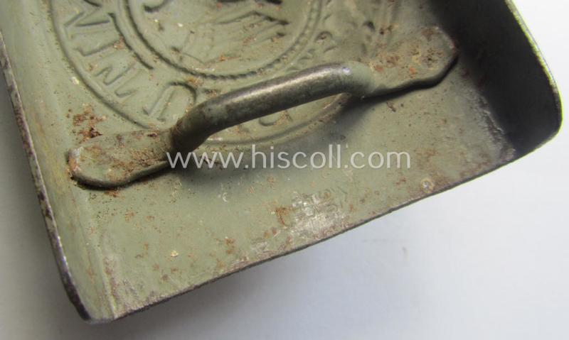 Minimally used, WH (Heeres) field-grey-coloured- and/or steel-based belt-buckle being a clearly maker-marked example that comes mounted onto its maker- (ie. 'Schmöle & Comp - Menden'-) marked and/or '1941'-dated leather-based tab