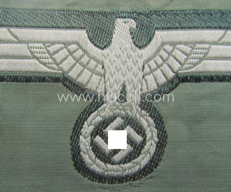 WH (Heeres) early-war-period- and/or greyish-coloured breast-eagle of the: 'M40'-pattern as was executed in the 'BeVo'-weave pattern on a darker-green-coloured background