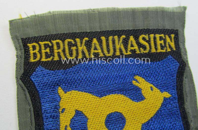 Attractive, 'BeVo'-type armshield (of the second pattern-) entitled: 'Bergkaukasien', being a piece as intended for a volunteer who served within the 'Deutsche Wehrmacht' ie. within the 'Berg- o. Nord-Kaukasisches Legion'