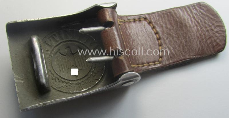 WH (Heeres) 'standard-pattern', field-grey-toned- and aluminium-based belt-buckle being a maker- (ie. 'Jul. Kremp'-) marked- and/or: '1939'-dated example that comes mounted onto its leather-based tab