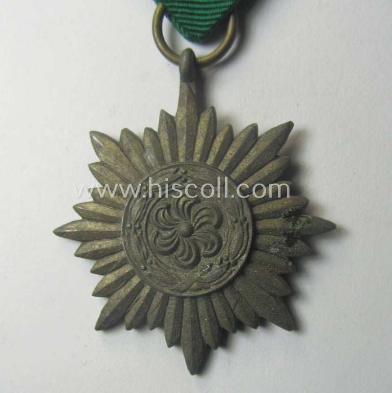 WH-related 'Verdienstauszeichnung für Angehörige der Ostvölker, 3. Kl. in Bronze ohne Schwn.' (being a 'Feinzink'-based example that comes mounted onto its period ribbon ie. 'Bandabschnitt')