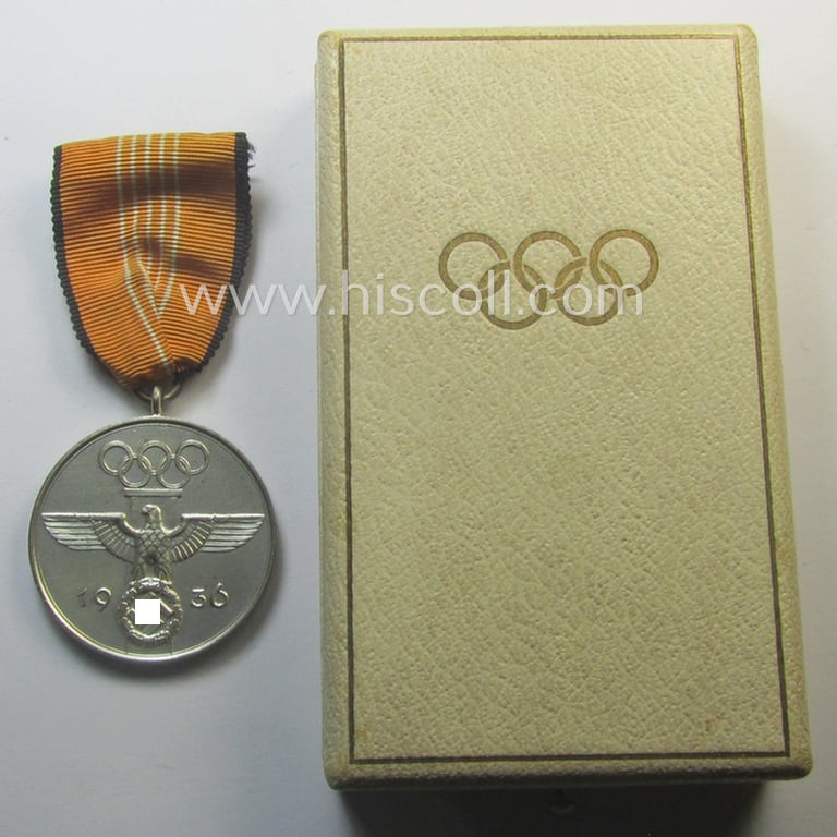 Superb, 'Deutsche Olympia-Erinnerungsmedaille 1936' being a non-maker-marked example that comes mounted onto its original ribbon (ie. 'Bandabschnitt') and that comes stored in its typical, beige-white-coloured etui