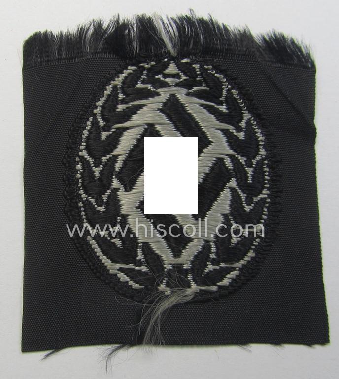 EM- (ie. NCO-) type, so-called: 'Schutzmannschaften' (or: 'Schuma') cap-badge as executed in greyish-coloured thread onto a black-coloured- (ie. 'SS-Polizei'- ie. 'SD'-related-) background