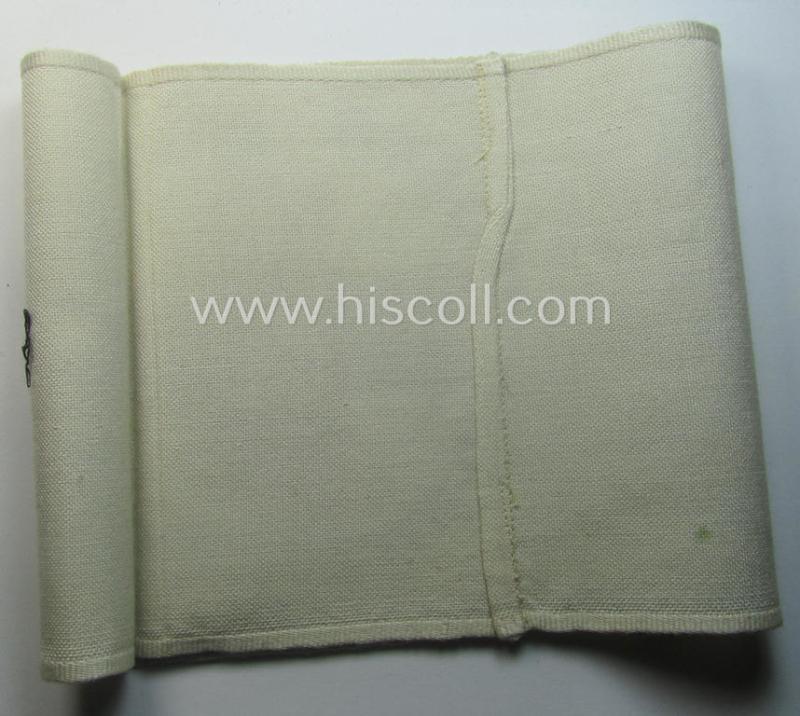 Linnen-based- and/or neatly 'machine-embroidered', beige-white-coloured DRK- (ie. 'Deutsches Rotes Kreuz'-) armband (ie. 'Armbinde') as was intended for the staff-members serving with the: 'Deutsches Rotes Kreuz' (or: German Red Cross)