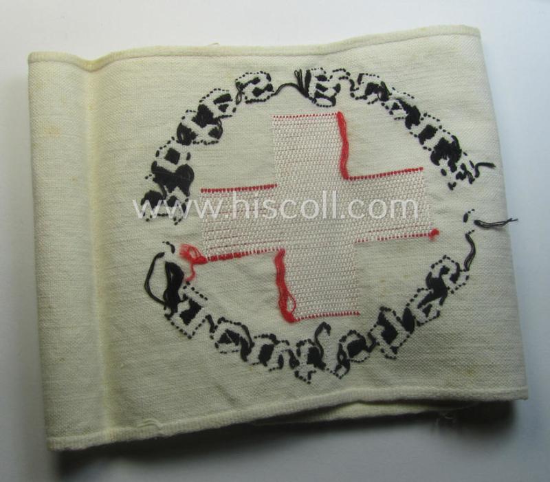Linnen-based- and/or neatly 'machine-embroidered', beige-white-coloured DRK- (ie. 'Deutsches Rotes Kreuz'-) armband (ie. 'Armbinde') as was intended for the staff-members serving with the: 'Deutsches Rotes Kreuz' (or: German Red Cross)