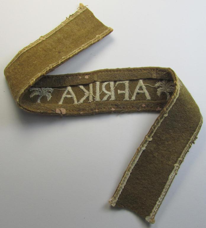 Attractive, WH (LW o. Heeres) cuff-title (ie. 'Ärmelstreifen') entitled: 'Afrika' (being a period-shortened- and woolen-based example that comes in a clearly issued- and/or worn condition)