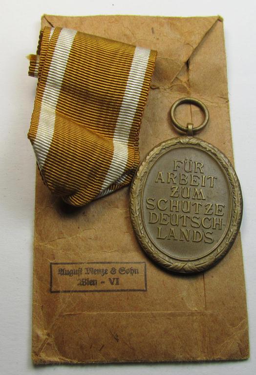 Superb medal-set: 'Deutsches Schutzwall Ehrenzeichen' (aka: 'Westwall'-medal) being a non-maker-marked- and/or: 'Buntmetall'-based specimen that comes packed in its original pouch of issue by the: 'August Menze & Sohn'-company