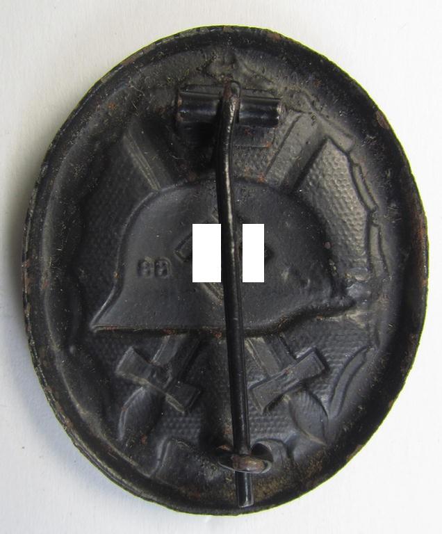 Moderately used and neatly maker- (ie. '88'-) marked example of a black-class wound-badge (or: 'Verwundeten-Abzeichen in Schwarz') being an example that was produced by the desirable maker (ie. 'Hersteller') named: 'Werner Redo'