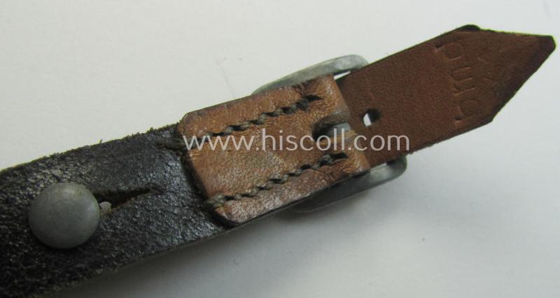 Early-war-period- and 'standard-issue'-pattern, black-coloured- and/or leather-based WH helmet-strap (ie. 'Riemen für Stahlhelm') being an: 'BMD 41'-marked example that comes in a never mounted ie. 'virtually mint' condition