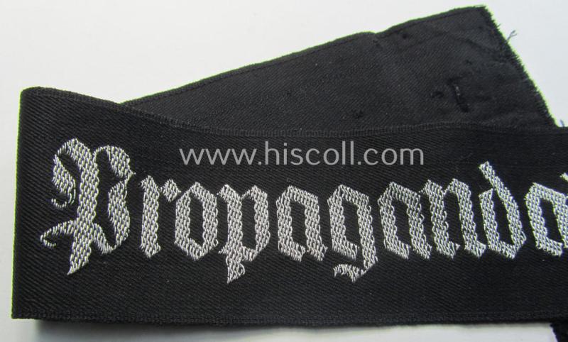 WH (Heeres) related cuff-title (ie. 'Ärmelstreifen') being a typical black-coloured- and linnen-based example showing the (neatly silver-toned- and 'flatwire'-woven!) text that reads: 'Propagandakompanie'