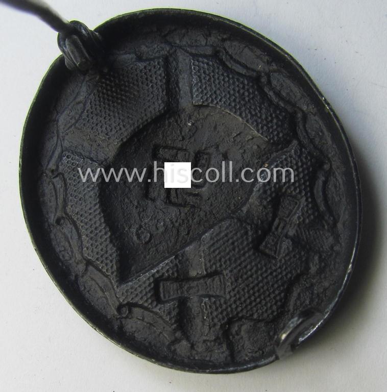 Black-class wound-badge (or: 'Verwundeten-Abzeichen in Schwarz') being a neatly maker- (ie. '65'-) marked example that was produced by the maker (ie. 'Hersteller') named: 'Klein & Quenzer'