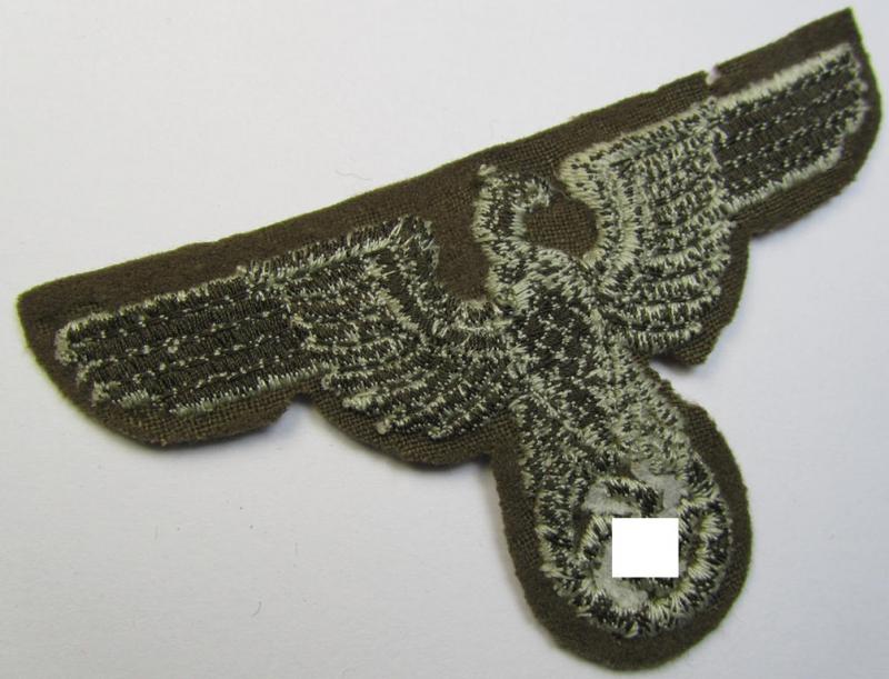 Attractive, machine-embroidered arm-eagle (ie. 'Ärmeladler') as was specifically intended for usage on the brownish-green-coloured tunics of officials of the: 'Reichsministerium für besetzte Ostgebiete' (ie. 'R.M.b.O.')